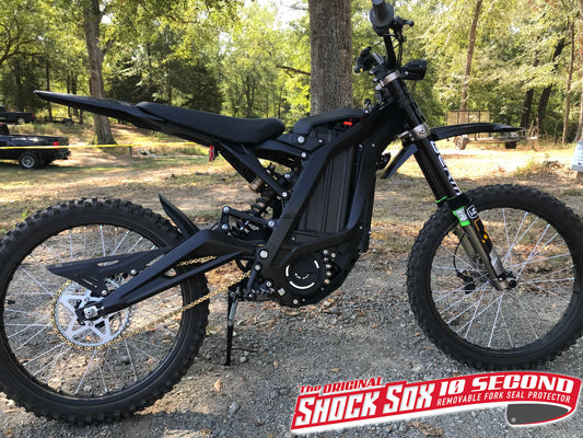 A Surron with green 4U Shock Sox.