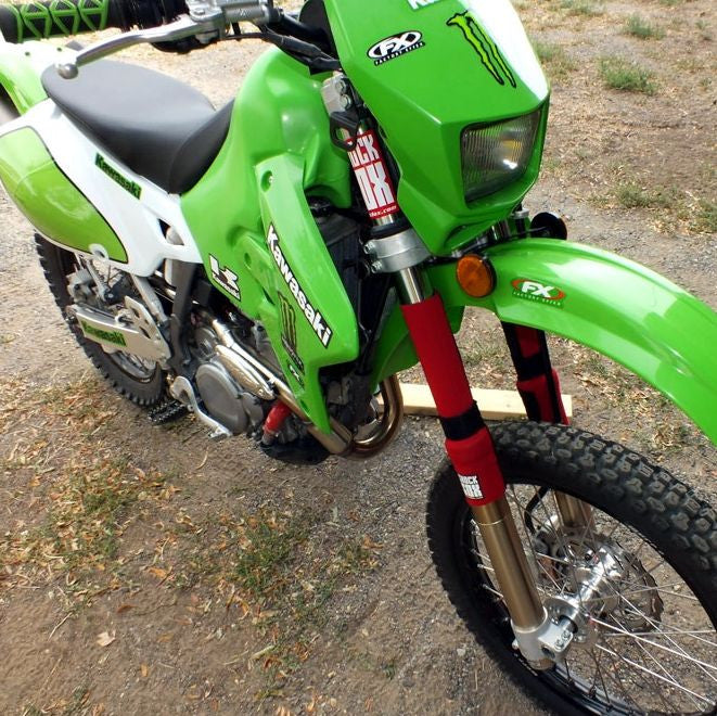 A picture of a Kawasaki dual sport bike with 13in red Shock Sox on it.