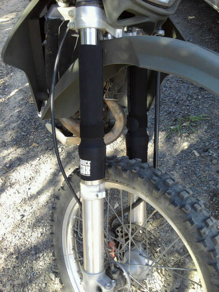 A closeup of a DRZ with black 13in Shock Sox on it.