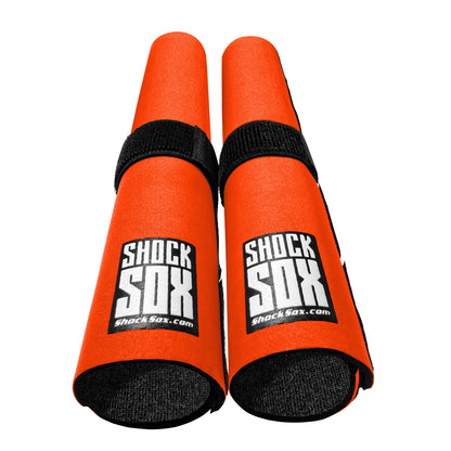 Pair of orange 13in Shock Sox on a white background