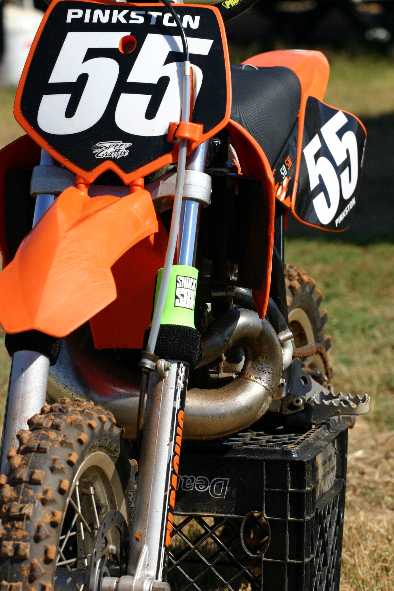 A KTM dirt bike with green Shock Sox on it.