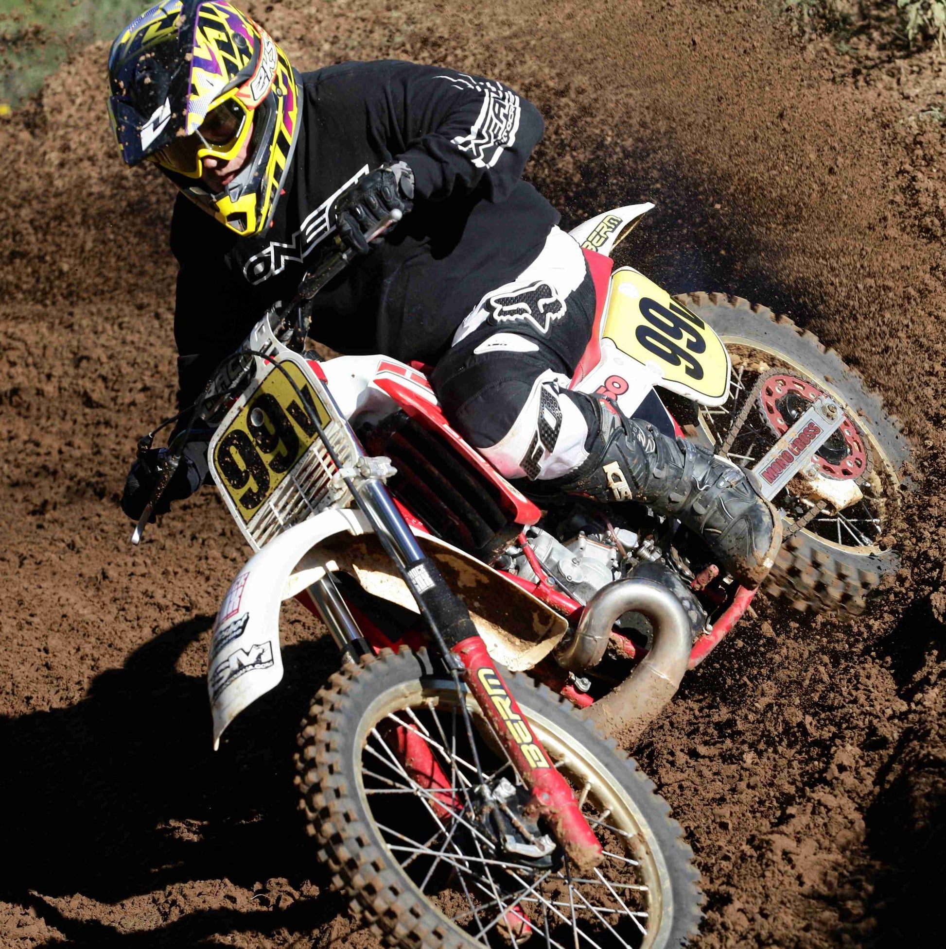 A picture of a vintage dirtbike with black Shock Sox on it.