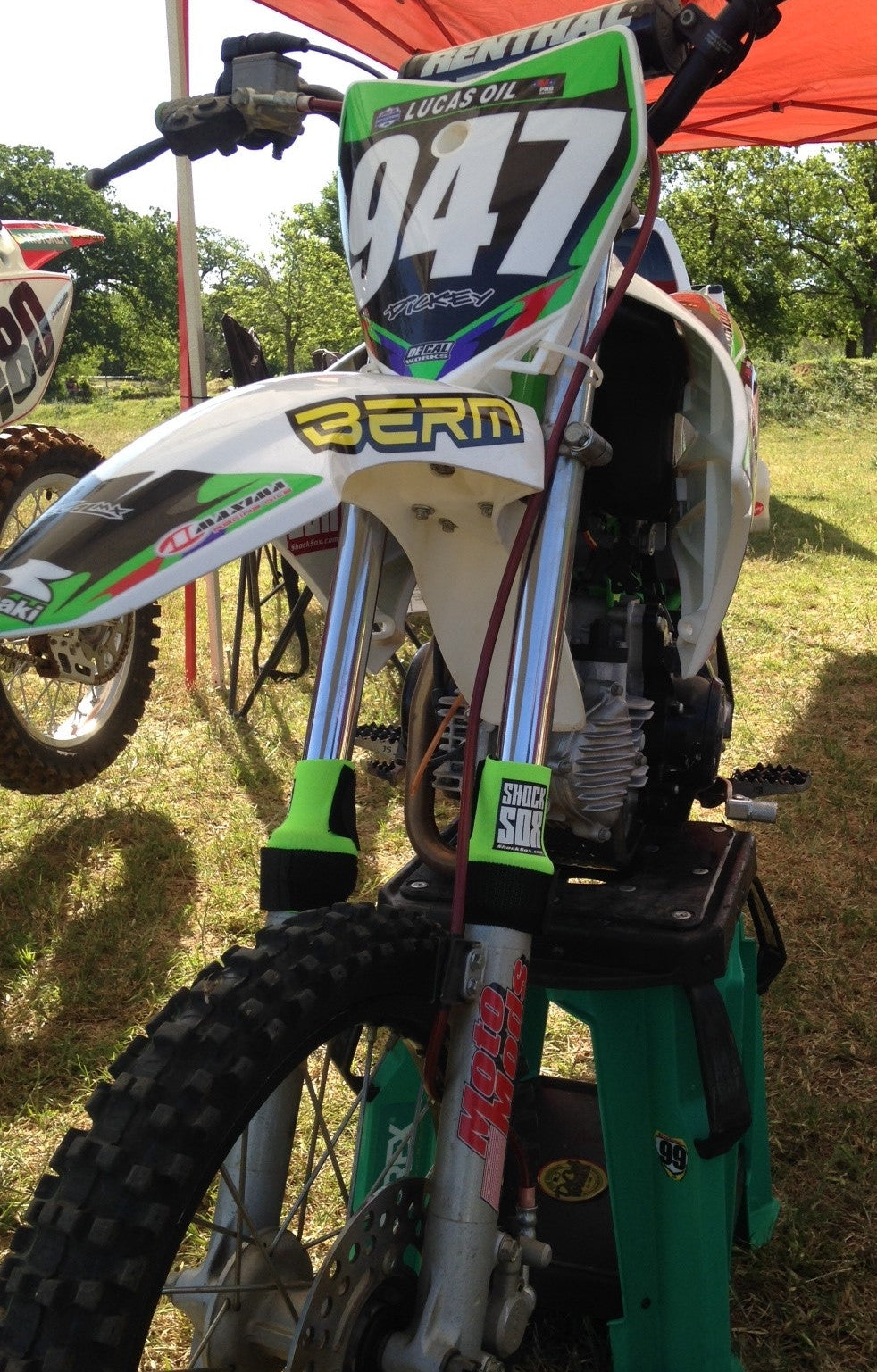 A dirtbike with green Shock Sox on it.