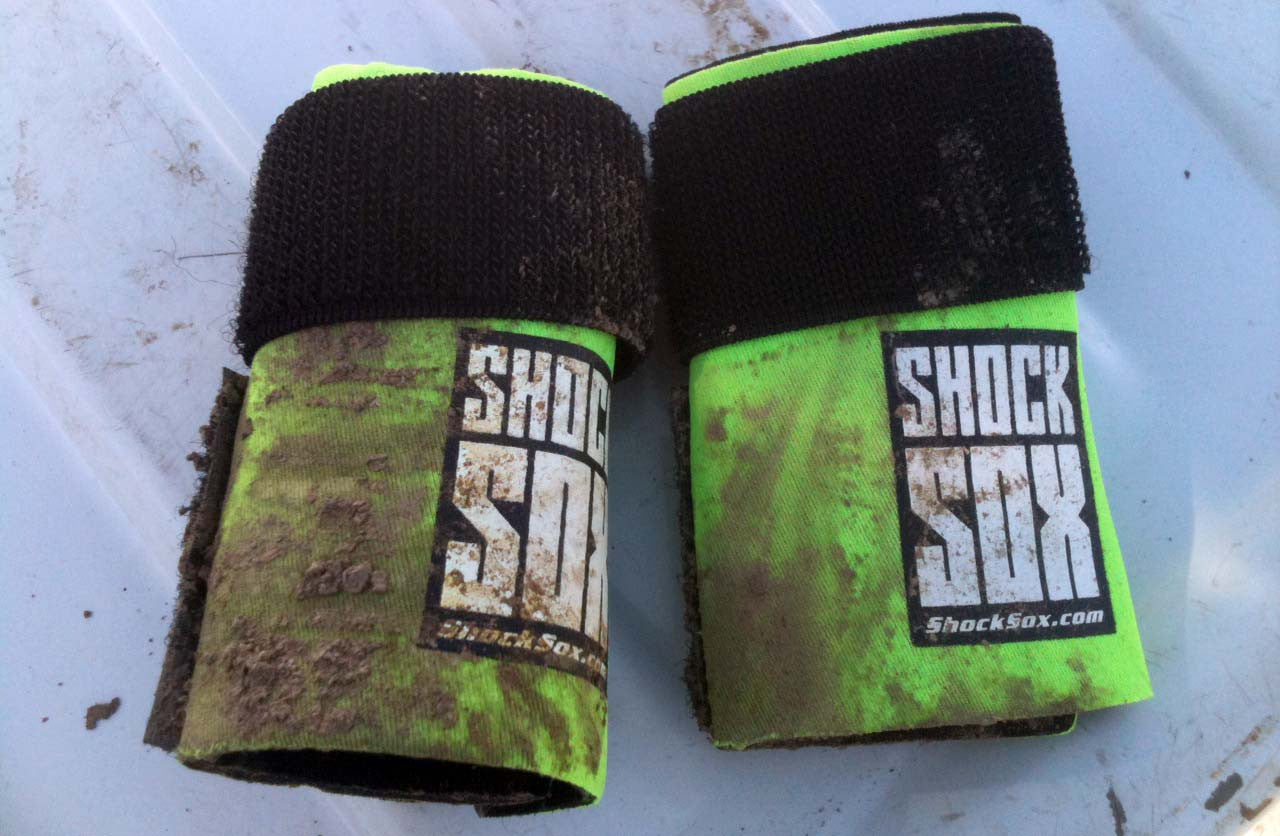 A pair of green 4U Shock Sox dirty after being used.