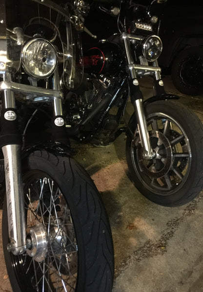 A picture of a street bike with black Shock Sox on it.