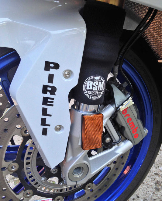 A closeup of a street bike fork with black BSM Shock Sox on it.
