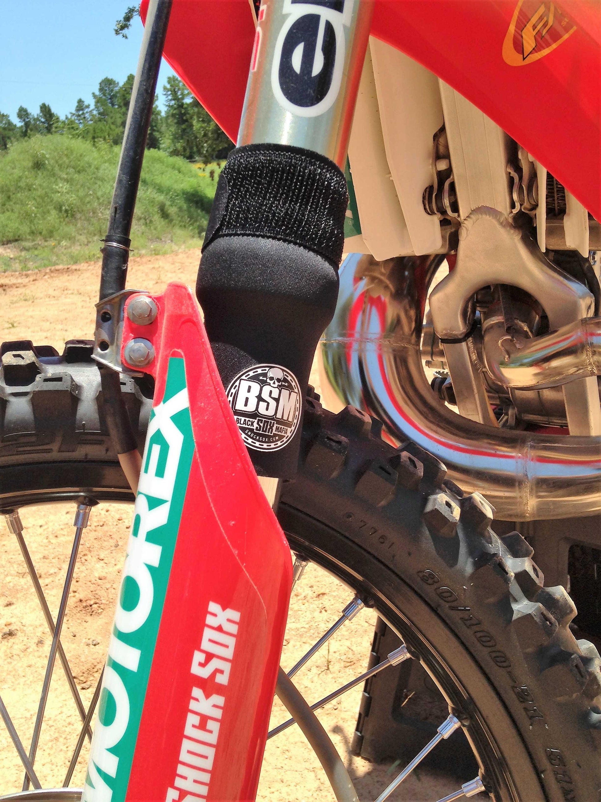 A KTM dirt bike with black BSM Shock Sox on it.