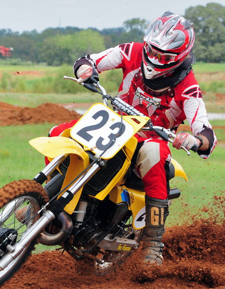 A picture of a vintage dirtbike with black Shock Sox on it.