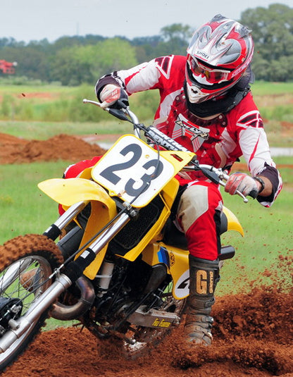 A picture of a vintage dirtbike with black Shock Sox on it.