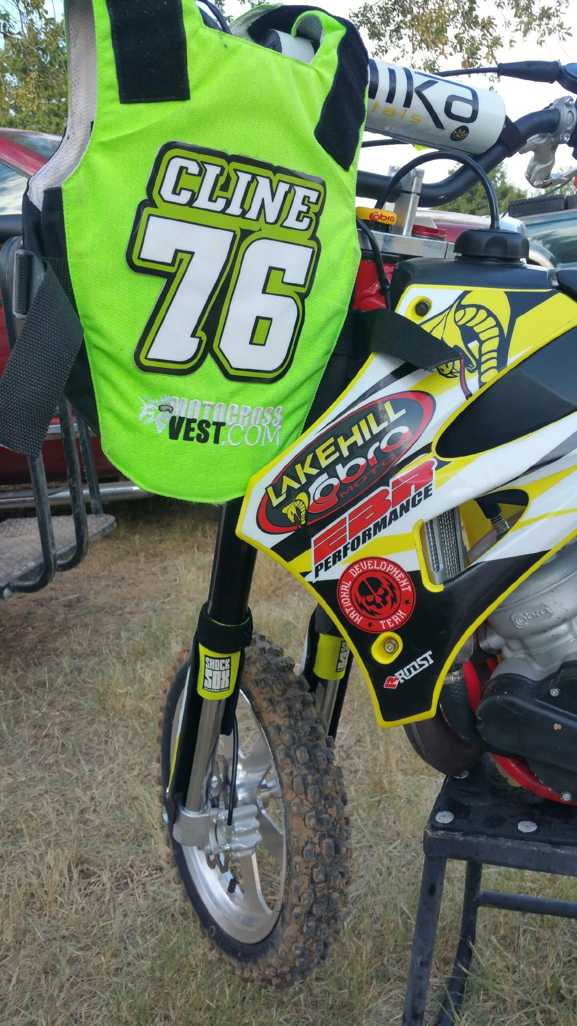 A picture of a Cobra dirt bike with yellow Shock Sox on it.