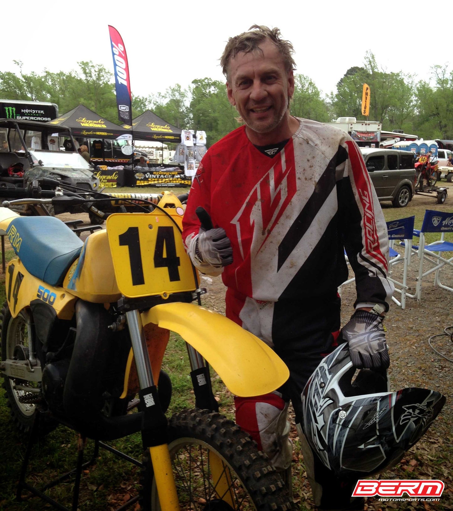 A picture of a vintage dirtbike with black Shock Sox on it.