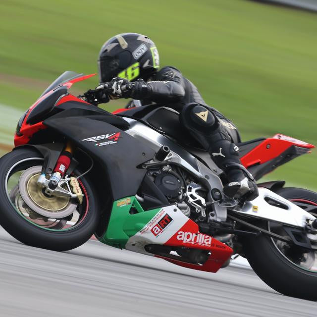 A picture of someone racing a street bike with red Shock Sox on it.