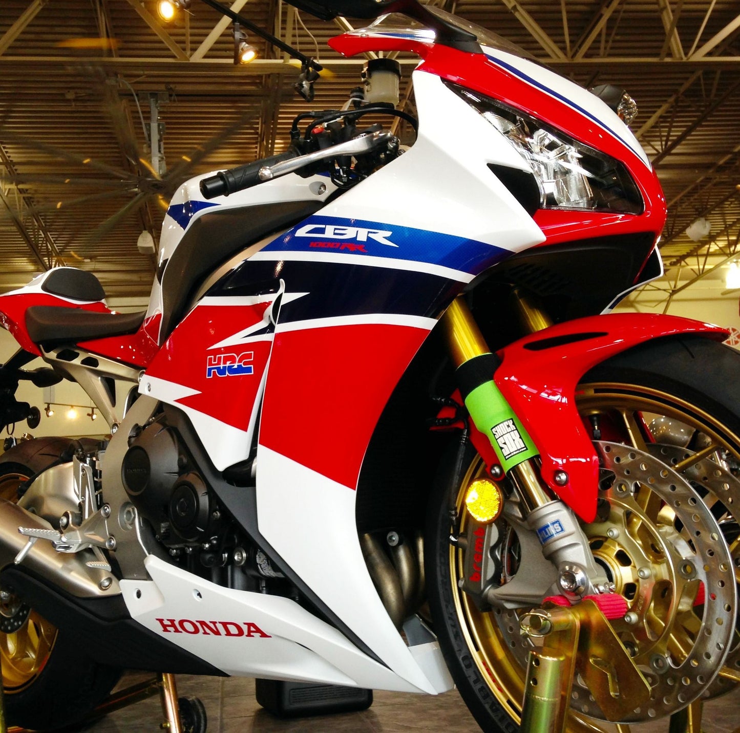 A Honda street bike with green Shock Sox on it.