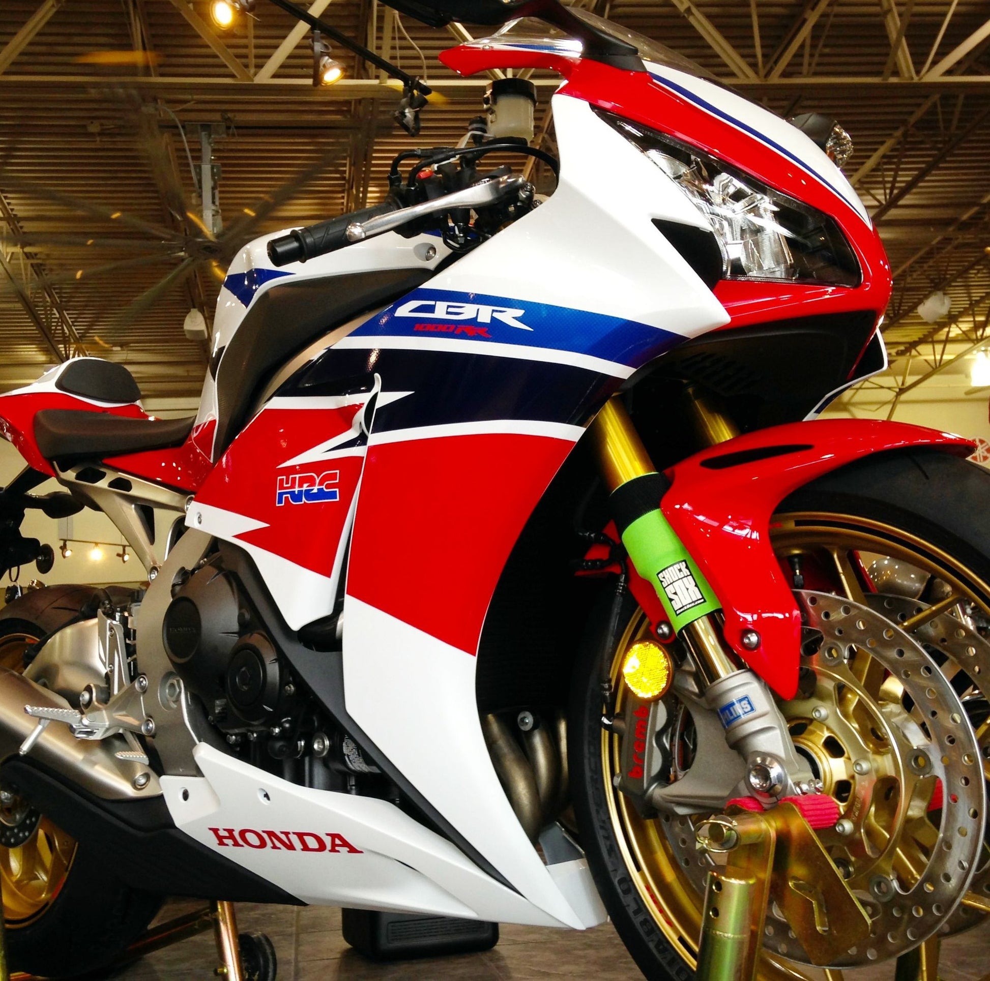 A Honda street bike with green Shock Sox on it.