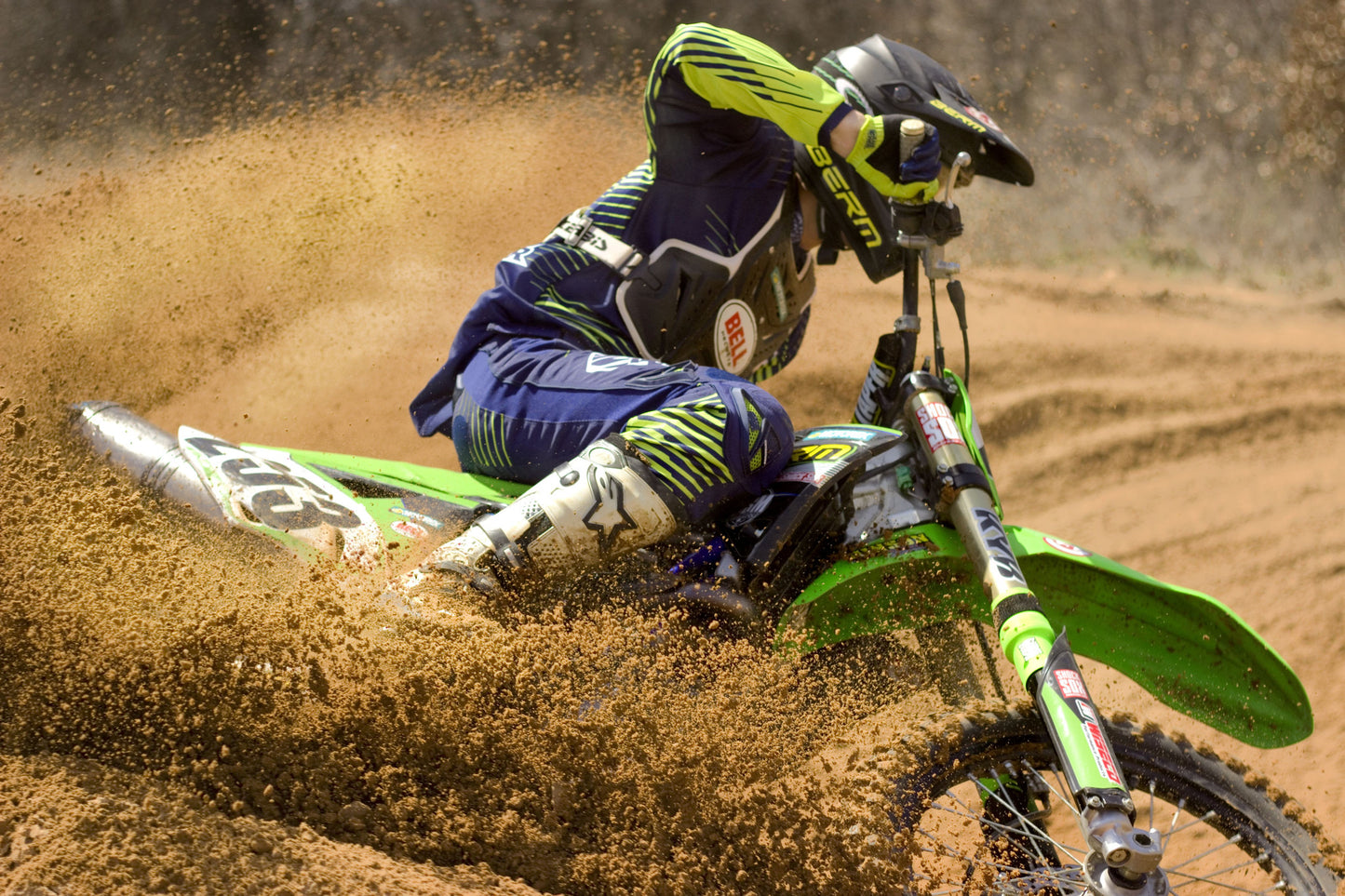 Someone riding a Kawasaki dirt bike with green Shock Sox on it.