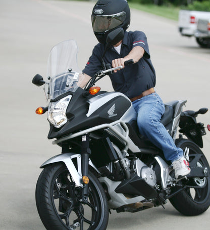 A guy riding a street bike with black Shock Sox on it.