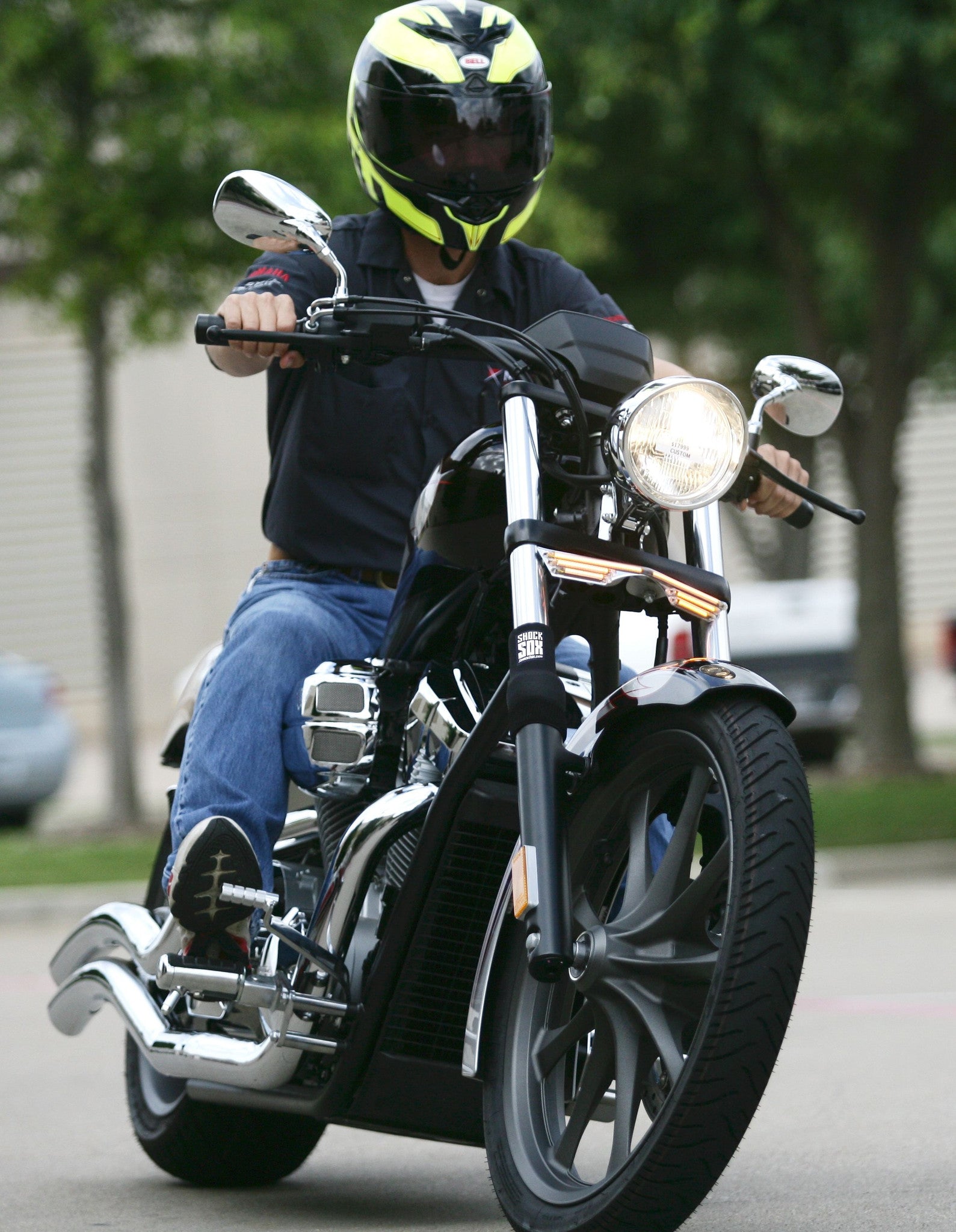 A guy riding a Harley with black Shock Sox on it