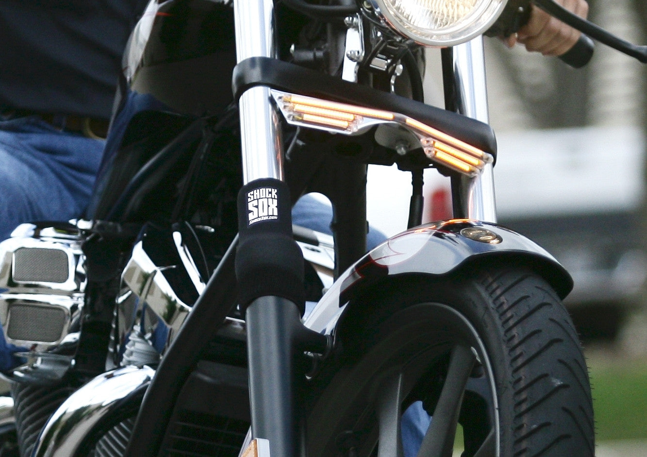 A close up of a street bike with black Shock Sox on it.