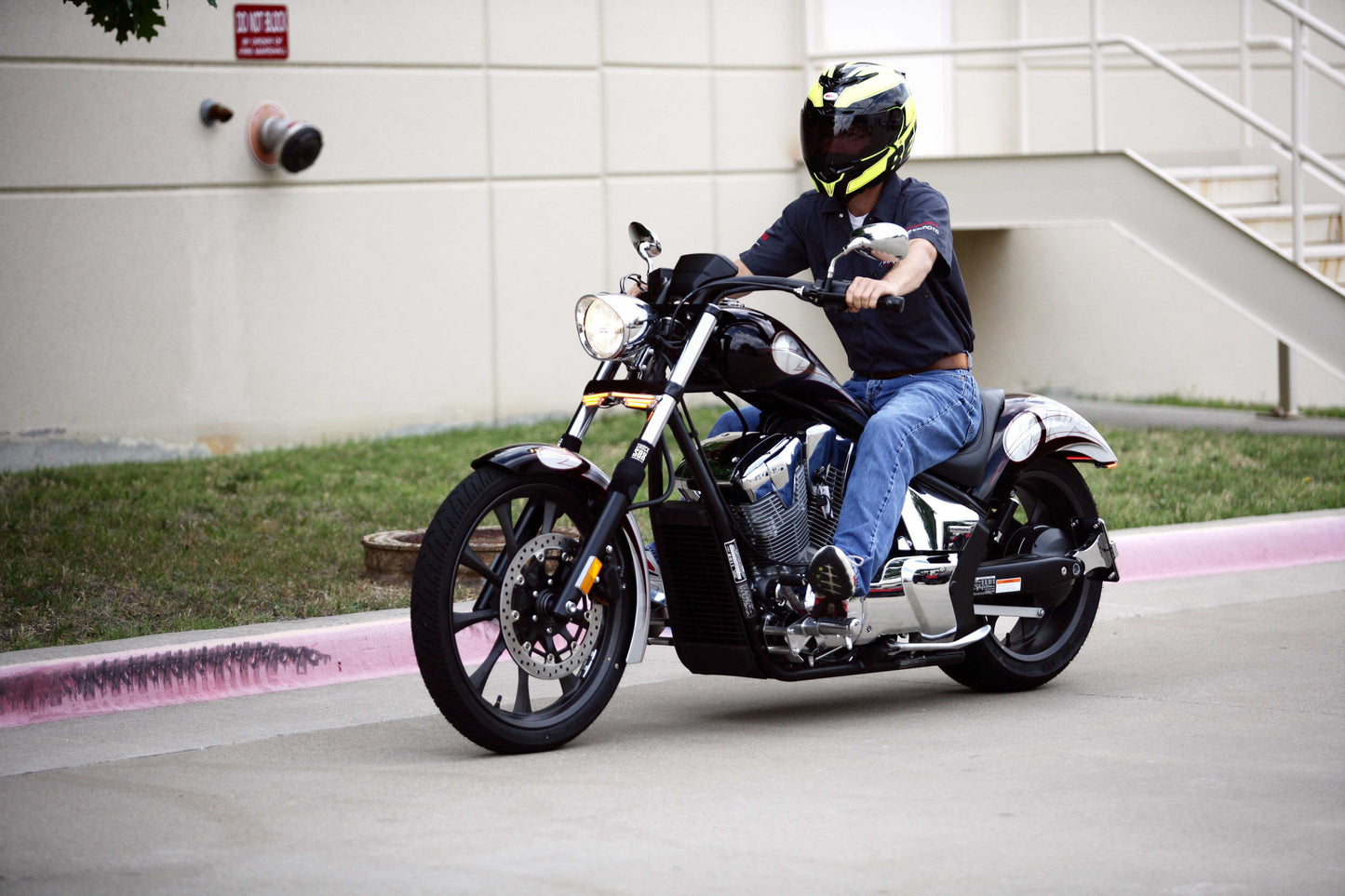 A guy riding a black street bike with Shock Sox on it.