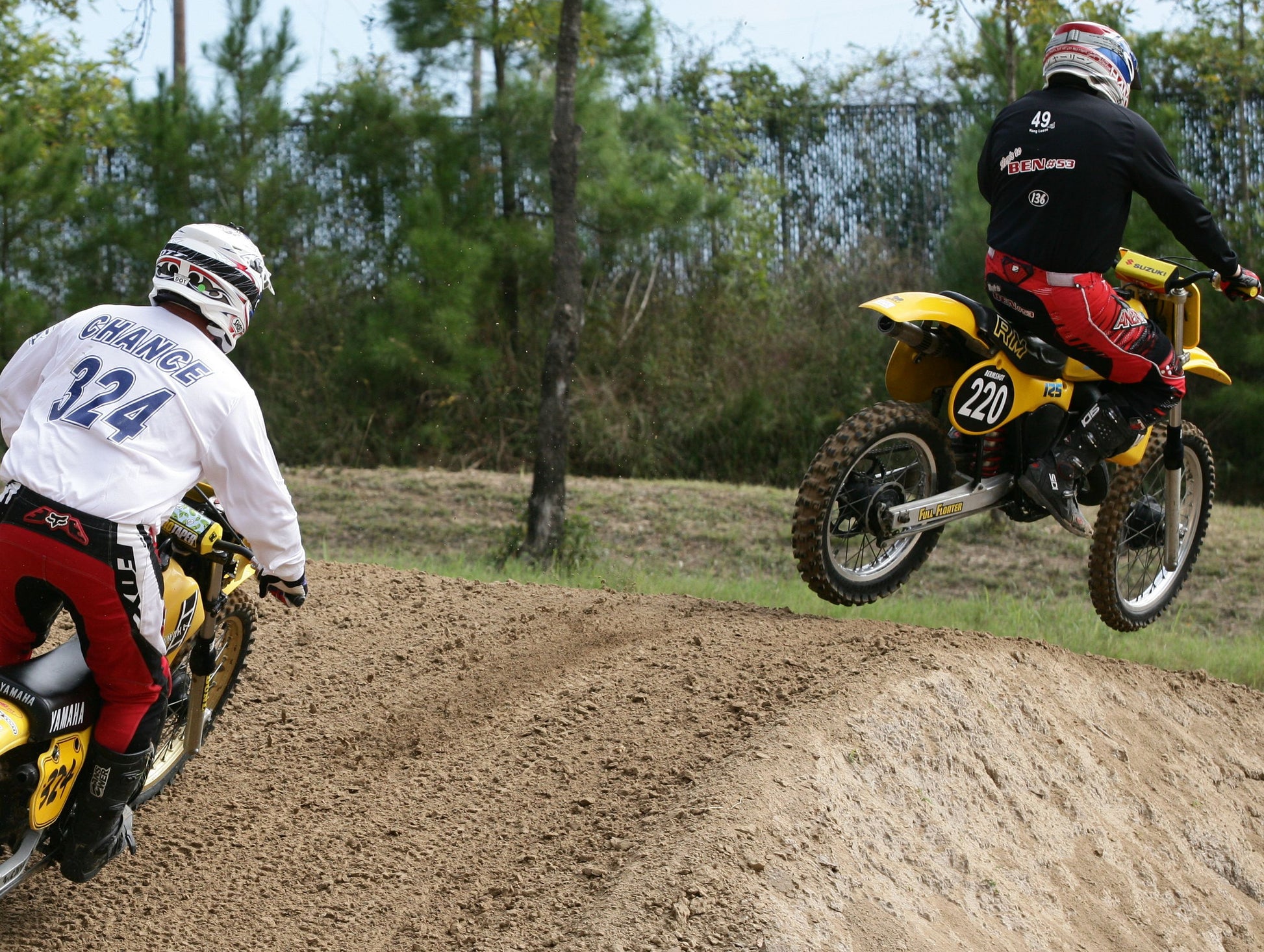 Someone riding a vintage dirtbike with black Shock Sox on the bike.
