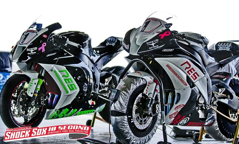A picture of a couple street bikes with red and green Shock Sox on them.