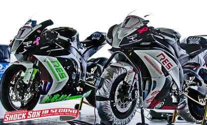 A picture of a couple street bikes with red and green Shock Sox on them.