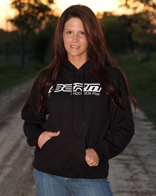 A lady standing with a black hoodie on that has a Berm Shock Sox logo on it