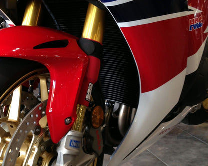 A closeup on red Shock Sox on a street bike.